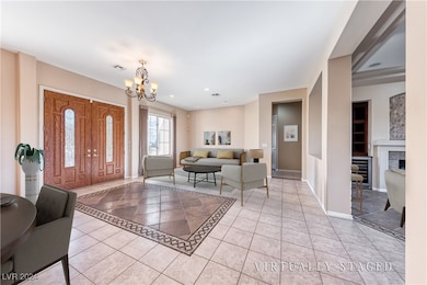 Entryway with a fireplace, light tile patterned fl
