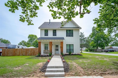 View of front of home with a shingled roof, a porch, and board and batten siding