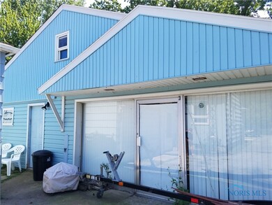 This garage/shop has a concrete floor, steps to se