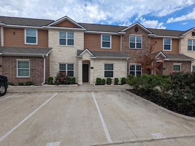 Traditional-style house featuring stone siding and uncovered parking