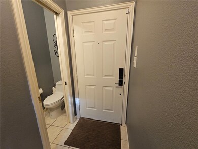 Bathroom featuring tile patterned floors and toile