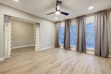 Spare room featuring a ceiling fan, light wood-style floors, and recessed lighting