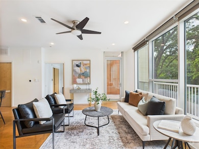 Living room featuring ceiling fan, wood finished 