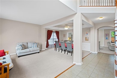 Enter to formal living room and dining.  Neutral tile and carpet in light beige tones.