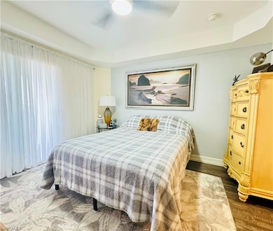 Bedroom with dark wood-type flooring and ceiling f