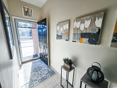 Foyer entrance featuring light tile patterned floo