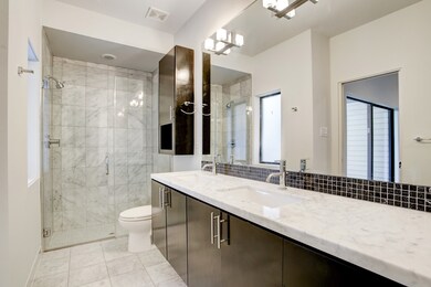 En-suite bath on the first level offers fully mirr