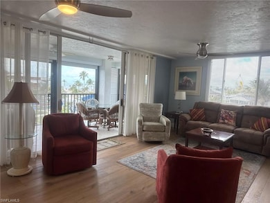 Living room with wood finished floors, ceiling fan