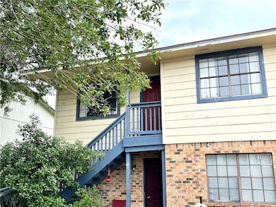 View of exterior entry with brick siding
