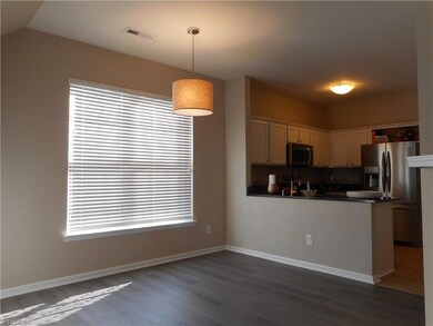 Dining Room: Room features include vinyl plank flooring for easy cleaning, two windows for natural lighting and a fireplace with gas logs for a cozy atmosphere on a cool winter evening. Over to the right side is the kitchen.