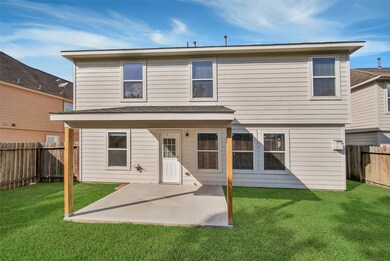 Backyard covered patio is a highlight of this home!