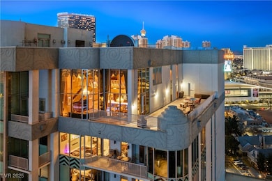 Rear view of property with a balcony and a city vi