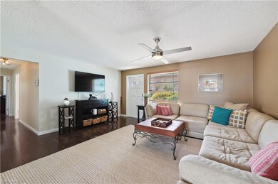 Living room featuring a textured ceiling, dark har