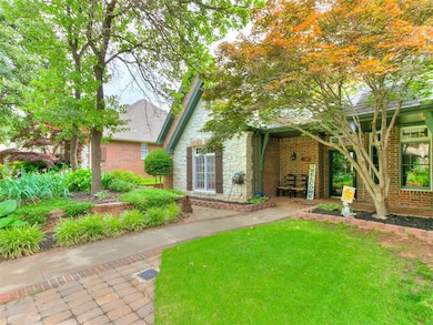 View of front of house with stone siding, brick siding, and a front yard