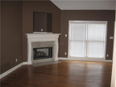 The den has soaring ceilings, recessed lighting, h