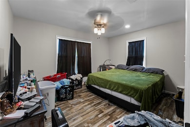 Bedroom with hardwood / wood-style flooring and ce