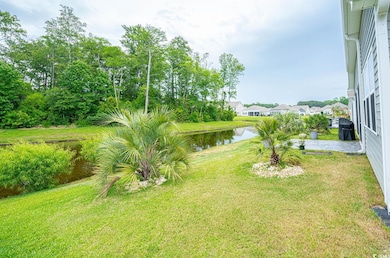 View of green lawn featuring a water view