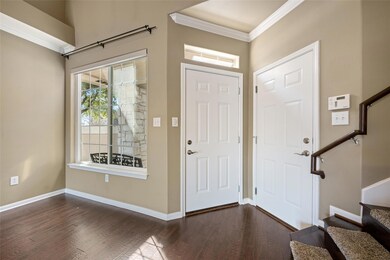 Entrance foyer with dark wood-style flooring, cro