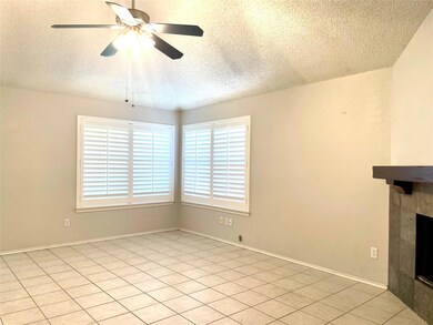 Large living room with corner FP, plantation shutt