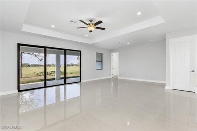 Unfurnished room featuring a tray ceiling, recesse