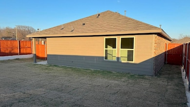 View of side of home featuring a lawn