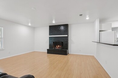 Unfurnished living room featuring wood finished f