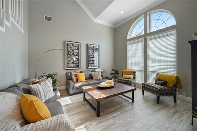 High ceilings and large windows allow abundant natural light to flow into the home.