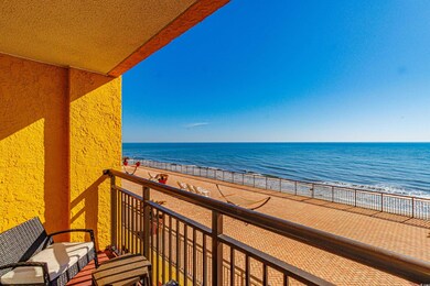 Balcony featuring a view of the beach and a water 