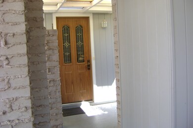 Carport door into house