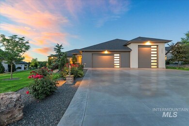 Prairie-style home featuring an attached garage, concrete driveway, and a lawn