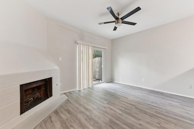 Unfurnished living room with baseboards, a firepl