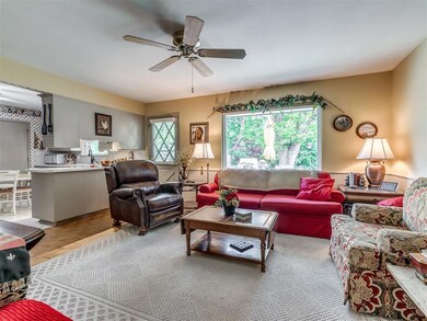 Living room featuring sink and ceiling fan
