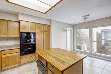 Large kitchen with island and desk has lots of storage!
