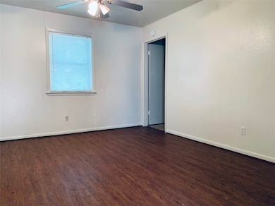 Empty room featuring dark wood-style flooring, a c