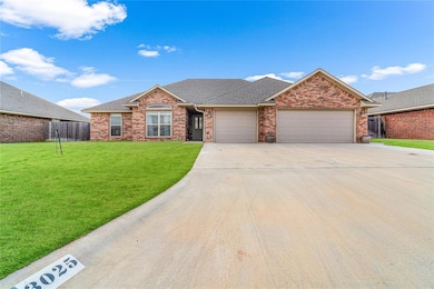 Ranch-style home with a garage and a front lawn