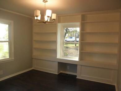 Dining room with built in book cases.  New lighting throughout the home.