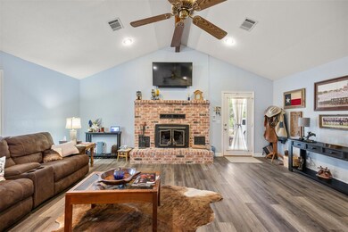 Living room with a ceiling fan, wood finished flo