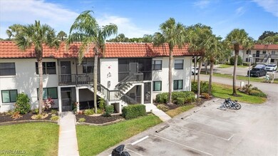 View of property featuring uncovered parking and s