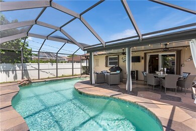 View of swimming pool featuring ceiling fan, a lan