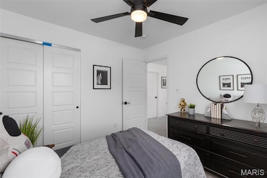 Carpeted bedroom featuring a closet and ceiling fan