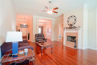 Large living room with wood floors and a gas fireplace.
