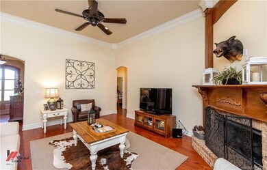 Corner fireplace, extensive crown molding and arch