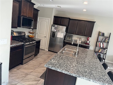 Kitchen featuring stainless steel appliances, dark