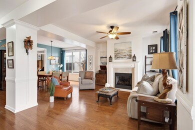 Living area with a ceiling fan, wood finished floo