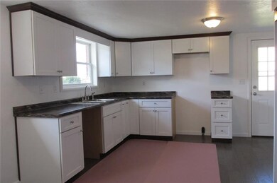 New white kitchen cabinetry with crown molding, ne