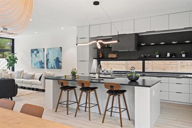 Kitchen featuring dark countertops, modern cabine