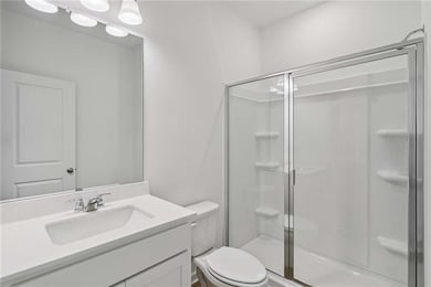 Bathroom with a stall shower and vanity