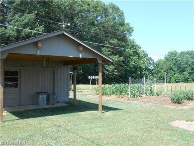 Exterior Front. New 16 x 16 Work shop with 8 x 16 Covered Shelter; Beautiful Garden spot; NOTICE THE WOODEN BOXES MOUNTED AT TOP OF GABLE END? CARPENTER BEE CATCHERS! THEY WORK!
