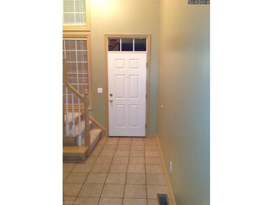 A ceramic tile floor adorns the welcoming foyer.