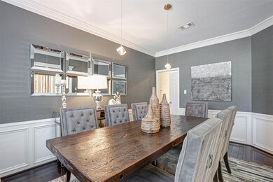 Dining room featuring a wainscoted wall, visible v